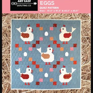 May include: A blue quilt pattern titled "Scrambled Eggs" with white chickens, red accents, and colorful squares. The quilt is available in two sizes: 41.5" x 41.5" and 65.5" x 65.5". The pattern is designed for confident beginners.