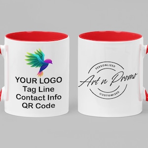 May include: Two white ceramic mugs with red rims and handles. The mug on the left has a colorful bird logo and the text "YOUR LOGO Tag Line Contact Info QR Code". The mug on the right has a black circle with the text "PERSONALIZED Art n Promo CUSTOMIZED".