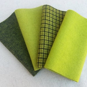 May include: Four rectangular fabric swatches arranged in a fan shape. The first is a dark olive green herringbone pattern, the second is a solid lime green, the third is a lime green and black houndstooth check, and the fourth is solid lime green.