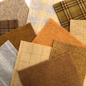 May include: Assortment of fabric swatches in various shades of brown, beige, and gray. The fabrics have different textures, including herringbone, plaid, and stripes.