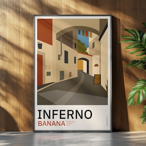 May include: A framed rectangular art print featuring a stylised illustration of a narrow street with beige buildings, arched passageways, and a dark grey road. The text INFERNO and BANANA are printed in bold black and red letters at the bottom.