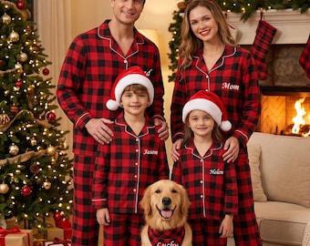 May include: Matching red and black buffalo plaid pajama sets with white piping and button-down fronts. The shirts feature embroidered names including Dad, Mom, Jason, and Helen. A golden retriever wears a matching plaid bandana labeled Lucky.