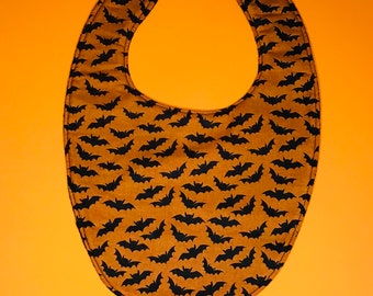 Black baby bats on orange baby bib