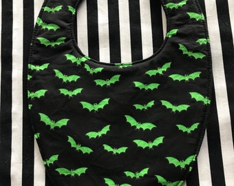 Green bats on black baby bib