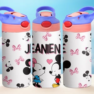 May include: Three white water bottles with pink and blue lids and handles. The bottles feature a Mickey Mouse and Minnie Mouse design with pink bows and the name "JEANINE" printed on the middle bottle.