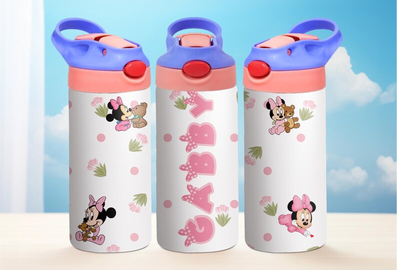 May include: Three pink and white water bottles with a blue lid and handle. Each bottle features a different image of Minnie Mouse and her friend. The middle bottle has the name "Gabby" written in pink letters.
