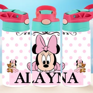 May include: Pink and white water bottle featuring a Minnie Mouse design. The bottle has a pink lid with a blue handle and a pink polka dot pattern. The Minnie Mouse design includes a pink bow and the name "ALAYNA" in pink letters.