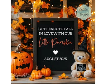 May include: A black chalkboard sign with the text "GET READY TO FALL IN LOVE WITH OUR Little Pumpkin AUGUST 2025". The sign is surrounded by autumn foliage, including pumpkins and a teddy bear wearing a witch's hat.