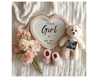 May include: A heart-shaped sign with the text "IT'S A Girl" and "DUE JULY 2026" is surrounded by baby items. A teddy bear holds an ultrasound image. Pink baby booties and a bouquet of pink and cream flowers complete the scene.