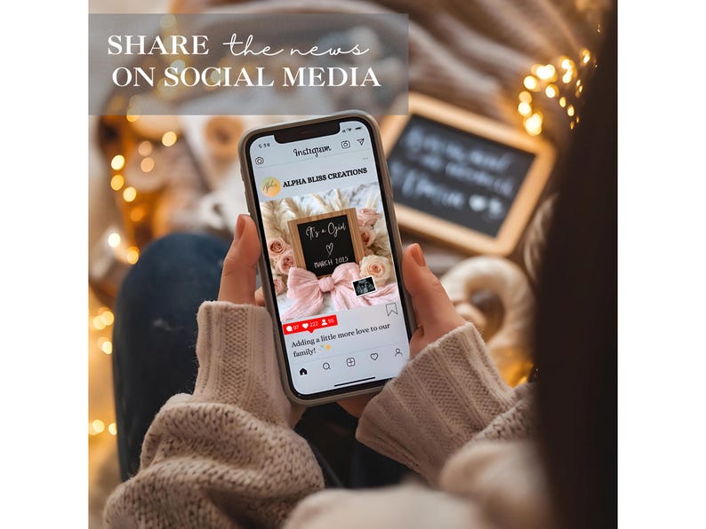 May include: A smartphone displaying a social media post announcing a new baby girl. The post features a pink and white bow, a sign that says "It's a Girl", and the text "Adding a little more love to our family".