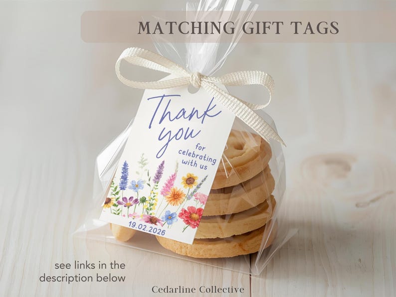 May include: A clear cellophane bag tied with a cream ribbon, containing a stack of cookies. A gift tag with the words "Thank you" and floral illustrations is attached. The tag also includes the date 19.02.2026.