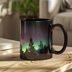 Ceramic Coffee Mug Northern Lights Design Aurora Borealis Artwork Quality Construction Microwave Safe Dishwasher Safe Pine Tree Silhouette Mountain Scene Night Sky Illustration Perfect Nature Gift Outdoor Enthusiast Present Camping