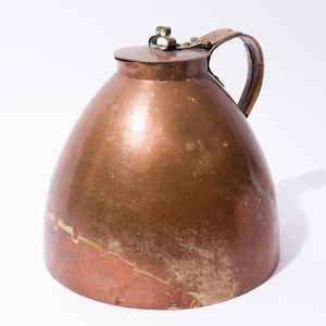 May include: A copper pitcher with a hinged lid and a handle. The pitcher has a rounded, bell-shaped body and a worn, aged patina.