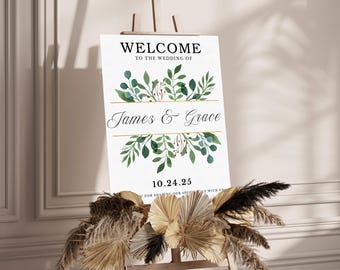 May include: A white welcome sign with green foliage and gold accents. The sign reads "Welcome to the wedding of James & Grace 10.24.25".