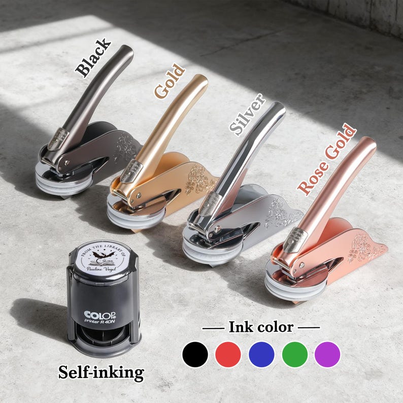 May include: Four metal seal embossers in black, gold, silver, and rose gold, with matching ink color options. A self-inking stamp is also shown. Text on the stamp reads "FROM THE LIBRARY OF Pauline Vogel".