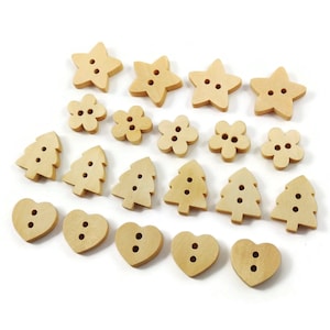 May include: A collection of wooden buttons in various shapes, including stars, flowers, trees, and hearts. The buttons are all a light brown color and have two holes each.