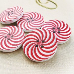 Peut inclure: Cinq boutons en bois avec un motif en spirale rouge et blanc. Les boutons ont un design à trois trous.