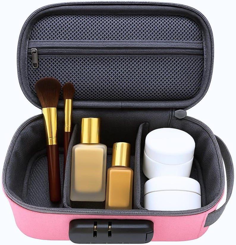 May include: A pink rectangular travel case with a black combination lock, featuring an open interior with a grey mesh zippered pocket, two makeup brushes with brown bristles, two rectangular glass bottles with gold caps, and two white jars.