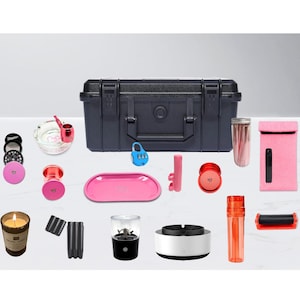Può includere: Una collezione di accessori per fumatori, tra cui una valigetta nera, un vassoio rosa, un macinino, un posacenere e una macchina per rollare. Altri articoli includono una candela, un barattolo di vetro e una custodia rosa.