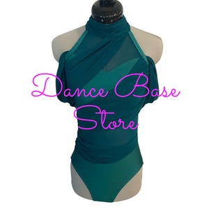 May include: A dark teal leotard featuring a high mock neck, sheer mesh overlay panels across the chest and shoulders, and short gathered sleeves. The garment displays the pink text Dance Base Store across the front center on a mannequin.