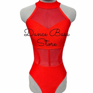 May include: A bright red leotard featuring a high mock neckline, sheer mesh panels across the chest and midsection, and a solid red fabric bodice. The text "Dance Base Store" is printed in black script across the center of the garment.