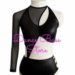 May include: A black leotard featuring a high neckline, one long sheer mesh sleeve, and a sleeveless side. The bodice includes a cutout design with sheer mesh panels and a high-waisted bottom with side strap details. The text Dance Base Store is visible.