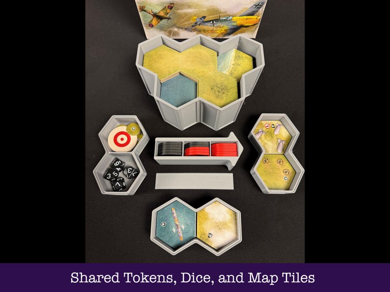 May include: A selection of grey game organisers containing dice, tokens, and map tiles. The set includes a target, dice, and hexagonal containers with yellow and blue game pieces. The image also shows a picture of airplanes.