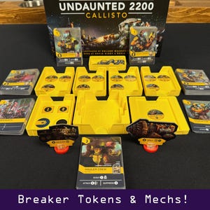 Peut inclure: Jeu de soci&eacute;t&eacute; "Undaunted 2200 Callisto" avec des jetons jaunes, des cartes et des figurines de m&eacute;chas. La bo&icirc;te de jeu est visible en arri&egrave;re-plan. Le texte "Breaker Tokens & Mechs!" est en bas.