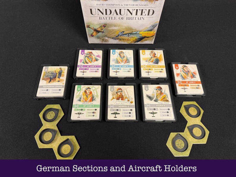 May include: The board game "Undaunted: Battle of Britain" is displayed with pilot cards and hexagonal aircraft holders. The game's box is visible, and the scene is set on a black surface.