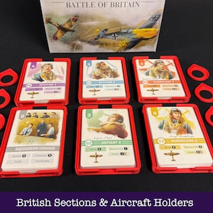 May include: A board game set featuring cards with pilot illustrations and aircraft, held in red card holders. The box is labelled "Battle of Britain". Includes red game pieces. The text "British Sections & Aircraft Holders" is visible.