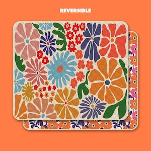 May include: Reversible fabric with a floral pattern. One side features a white background with colorful flowers, the other side has a pink background with white flowers.