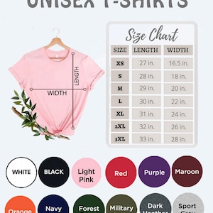 K&ouml;nnte beinhalten: Ein hellrosa Unisex-T-Shirt auf einem Kleiderb&uuml;gel, mit einer Gr&ouml;&szlig;entabelle, die L&auml;ngen- und Breitenma&szlig;e in Zoll anzeigt. Die Tabelle listet die Gr&ouml;&szlig;en XS bis 3XL auf. Farboptionen sind Wei&szlig;, Schwarz, Hellrosa, Rot, Lila, Burgunderrot, Orange, Marineblau, Waldgr&uuml;n, Milit&auml;rgr&uuml;n, Dunkelgrau und Sportgrau.