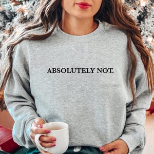 Puede incluir: Una sudadera gris con el texto "ABSOLUTELY NOT." impreso en negro.