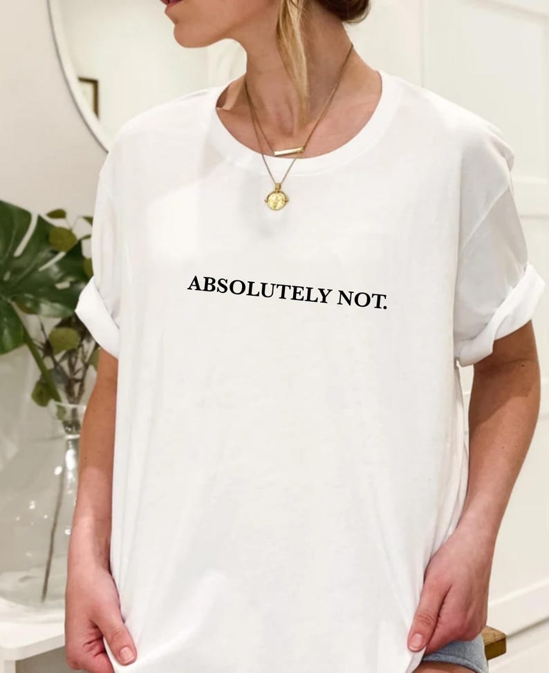 Puede incluir: Camiseta blanca con el texto "ABSOLUTELY NOT." impreso en negro.