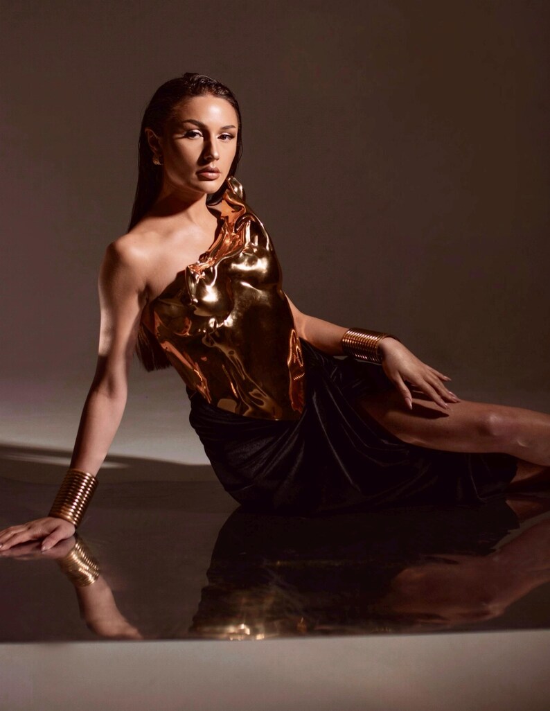 one shoulder corset,
gold acrylic corset,
wet look bustier,
metallic bustier,
luxury acrylic wear,
party outfit gift,
lacquer acrylic top,
high fashion corset,
luxury gift top,
stage wear bustier,
molten acrylic top,
DJ performance top,
dramatic outfit piece,