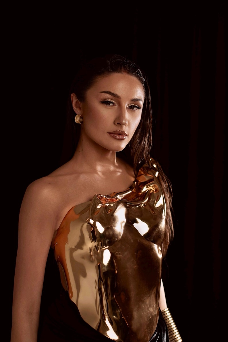 one shoulder corset,
gold acrylic corset,
wet look bustier,
metallic bustier,
luxury acrylic wear,
party outfit gift,
lacquer acrylic top,
high fashion corset,
luxury gift top,
stage wear bustier,
molten acrylic top,
DJ performance top,
dramatic outfit piece,