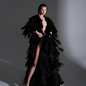 woman wearing dramatic black feather robe for luxury photoshoot