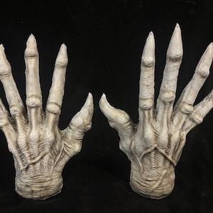 May include: A white ceramic mug with a black handle and the text "But First, Coffee" in a handwritten style. The mug is sitting on a wooden surface. The mug is approximately 4 inches tall.