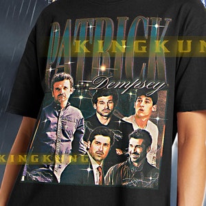Puede incluir: Camiseta negra unisex con un estampado gráfico de un grupo de hombres con el texto "Patrick Dempsey" en la parte delantera. La camiseta la lleva puesta una modelo frente a un fondo de cielo tormentoso.