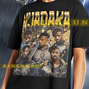 May include: Black t-shirt with a gold print of a group of men from the movie "Black Panther". The print includes the text "Wakanda" and "Erik Killmonger".