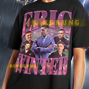 May include: Black t-shirt with a pink graphic print of a group of men wearing police uniforms. The graphic includes the text "KINGKUNG" and "WINTER".