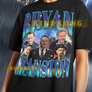 May include: Black t-shirt with a graphic print of Bryan Cranston's face from the TV show Breaking Bad. The graphic also includes the text "Bryan Cranston" in a blue and purple gradient.