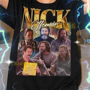May include: Black t-shirt with a graphic of Nick Offerman and the text "NICK Offerman". The design includes multiple images of the actor. The shirt is a unisex style.