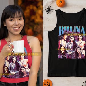 May include: A black tank top featuring a graphic of six women with the text "BRUNA MARQUEZINE" in a stylized font. The tank top is displayed on a white surface with Halloween decorations.