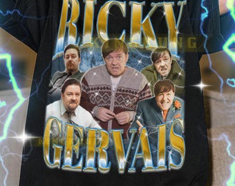 May include: Black t-shirt featuring the text "RICKY GERVAIS" in a gold and blue font, with a graphic of several men. The shirt is worn by a person. The text at the bottom of the shirt says the model is wearing an XL shirt.