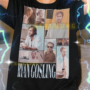 May include: Black unisex t-shirt featuring a collage of images of Ryan Gosling. The shirt has the name "RYAN GOSLING" printed in large, silver letters. The shirt is a classic crew neck style.