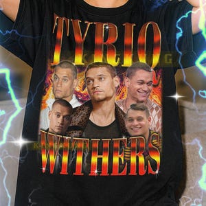 May include: Black unisex t-shirt featuring the text "TYRIO WITHERS" in a retro style with a portrait of a man. The shirt has a vintage aesthetic with a distressed look and a vibrant color palette.