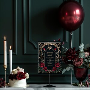 May include: A black and gold wedding invitation with a gothic design featuring red roses and the text "Josephine & Adrian" and the date "23.04.2023".
