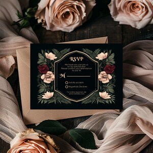 May include: A black RSVP card with a gold border and floral design. The text reads "RSVP" and "We hope you can join us on our special day! Please confirm your attendance by July 1st. M Joyfully accepts Regretfully Declines For online response visit www.website.com"