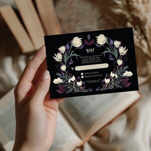 May include: Black RSVP card with floral design in white, purple, and green. The card includes the text "RSVP" and instructions for responding, with options to accept or decline. The card is held in a hand.
